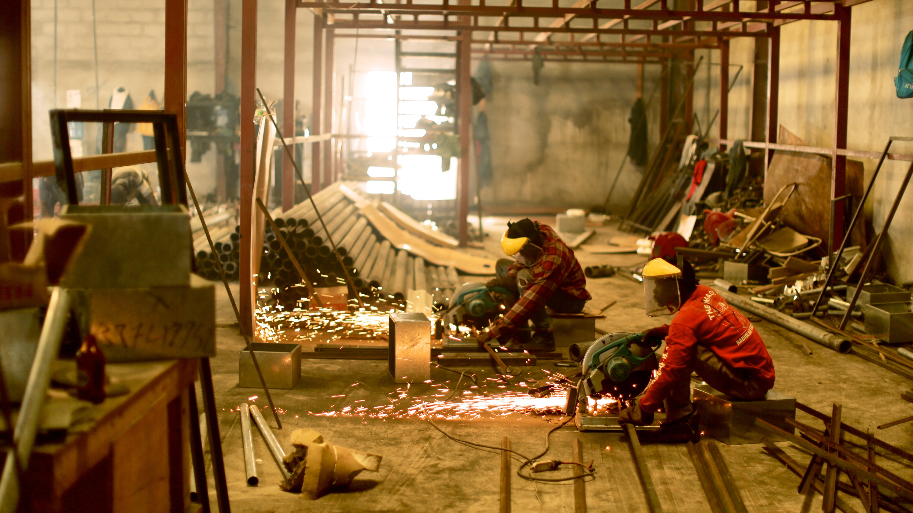 people in a metal workshop 